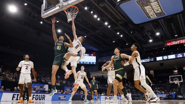 Colorado State Rams guard Nique Clifford (10) goes to the basket defended by Virginia Cavaliers guard Isaac McKneely (11) in the second half at UD Arena.